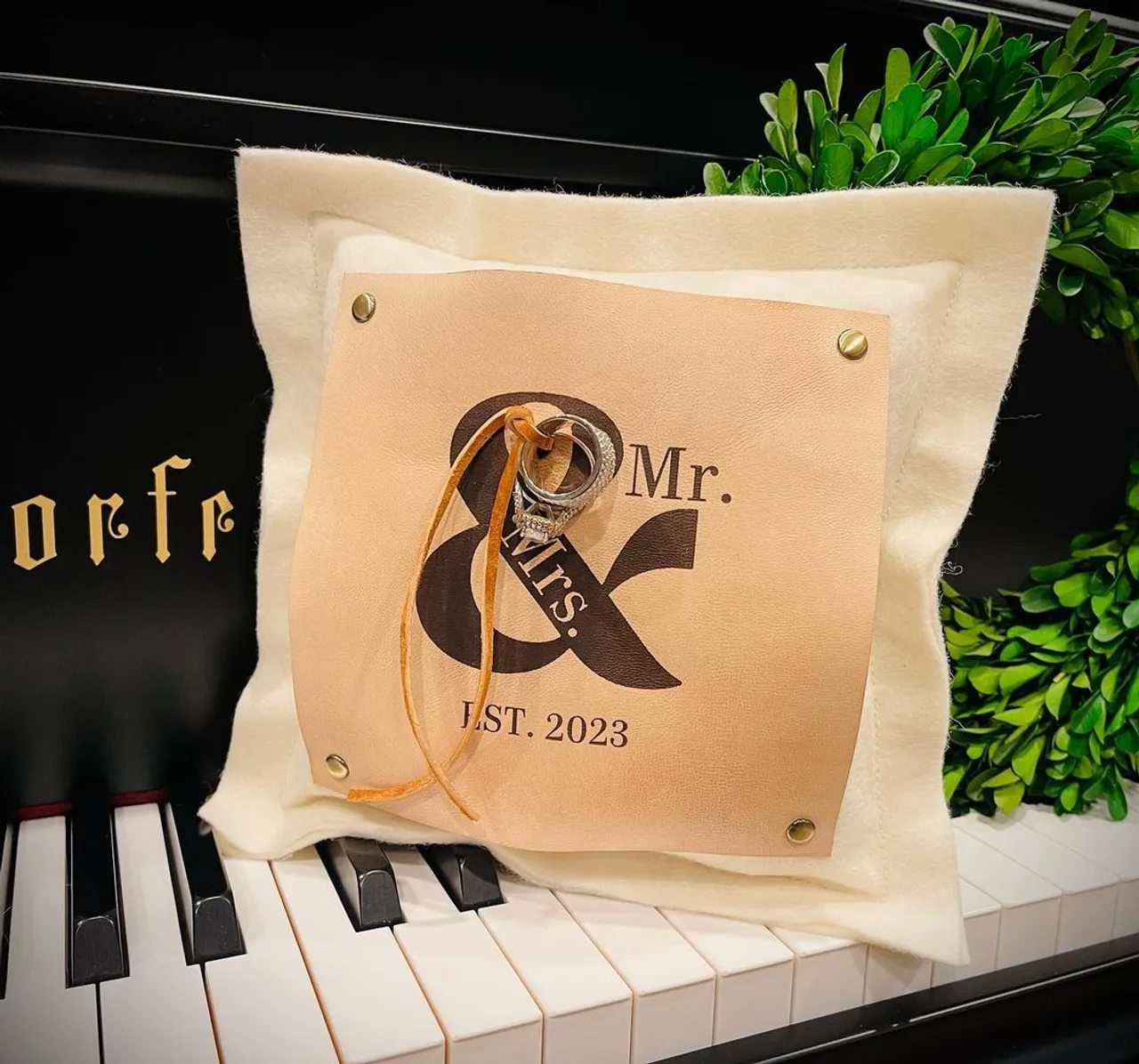 Wedding season is near and SUEDEKLOTH has new items just in time! This customizable ring bearer pillow will adorn your rings for your special day. Our 9" square ring pillow is made of 100% American felted wool and features a riveted, 5" engraved American veg tan natural oiled leather patch on the front that doubles as a lovely place to hold your vows. This pillow comes complete with a veg tan natural leather strap on the back so little hands can easily carry your rings down the aisle. Tie your rings with your choice of grosgrain ribbon or suede ribbon. After your big day you've got a beautiful keepsake to display with wedding photos and other treasured family decor. Each ring pillow we offer is 100% customizable with your specific details. We can create any design you'd like.
#wedding #weddingdress #weddingphotography #weddinginspiration #weddingguest #custom #leather #engrave #gift #bride #bridal #springwedding #ringpillow #groomsman #groomsmen #bouquet #bridesmaid #vow #flowergirl