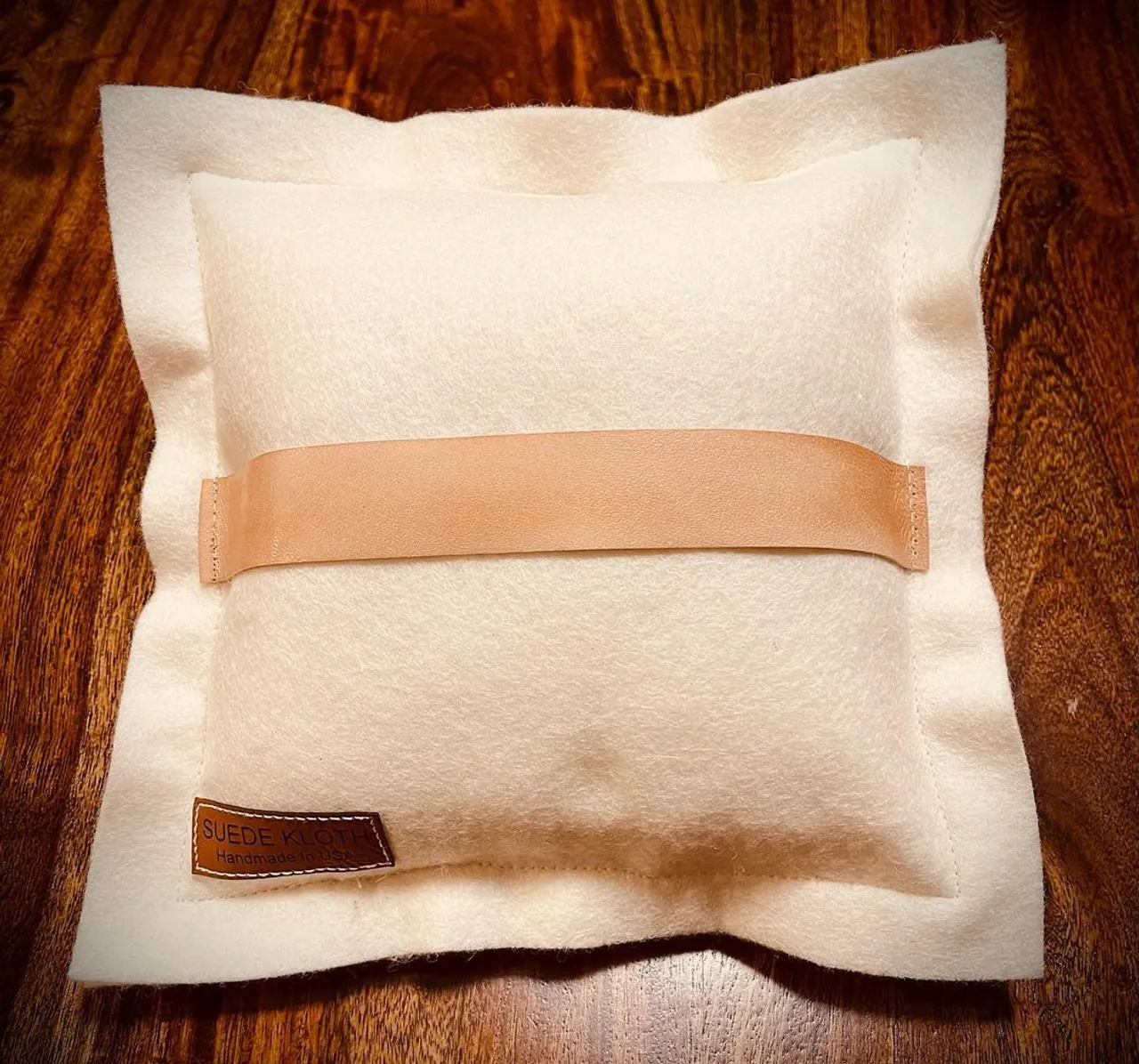 Wedding season is near and SUEDEKLOTH has new items just in time! This customizable ring bearer pillow will adorn your rings for your special day. Our 9" square ring pillow is made of 100% American felted wool and features a riveted, 5" engraved American veg tan natural oiled leather patch on the front that doubles as a lovely place to hold your vows. This pillow comes complete with a veg tan natural leather strap on the back so little hands can easily carry your rings down the aisle. Tie your rings with your choice of grosgrain ribbon or suede ribbon. After your big day you've got a beautiful keepsake to display with wedding photos and other treasured family decor. Each ring pillow we offer is 100% customizable with your specific details. We can create any design you'd like.
#wedding #weddingdress #weddingphotography #weddinginspiration #weddingguest #custom #leather #engrave #gift #bride #bridal #springwedding #ringpillow #groomsman #groomsmen #bouquet #bridesmaid #vow #flowergirl