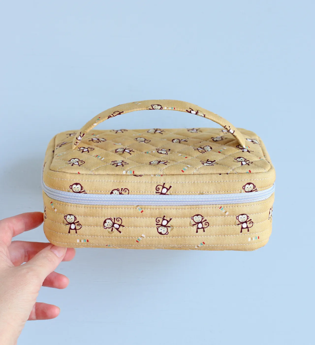 This zipper pouch with bedding and handle on the lid is perfect for carrying a mini rag doll or stuffed animal made with my sewing pattern or other small toys of similar size. Make this travel case yourself and your little one will take their little softies along for a walk or for a trip! Easy to follow and beginner friendly instructions will guide you through the sewing process from beginning to end.