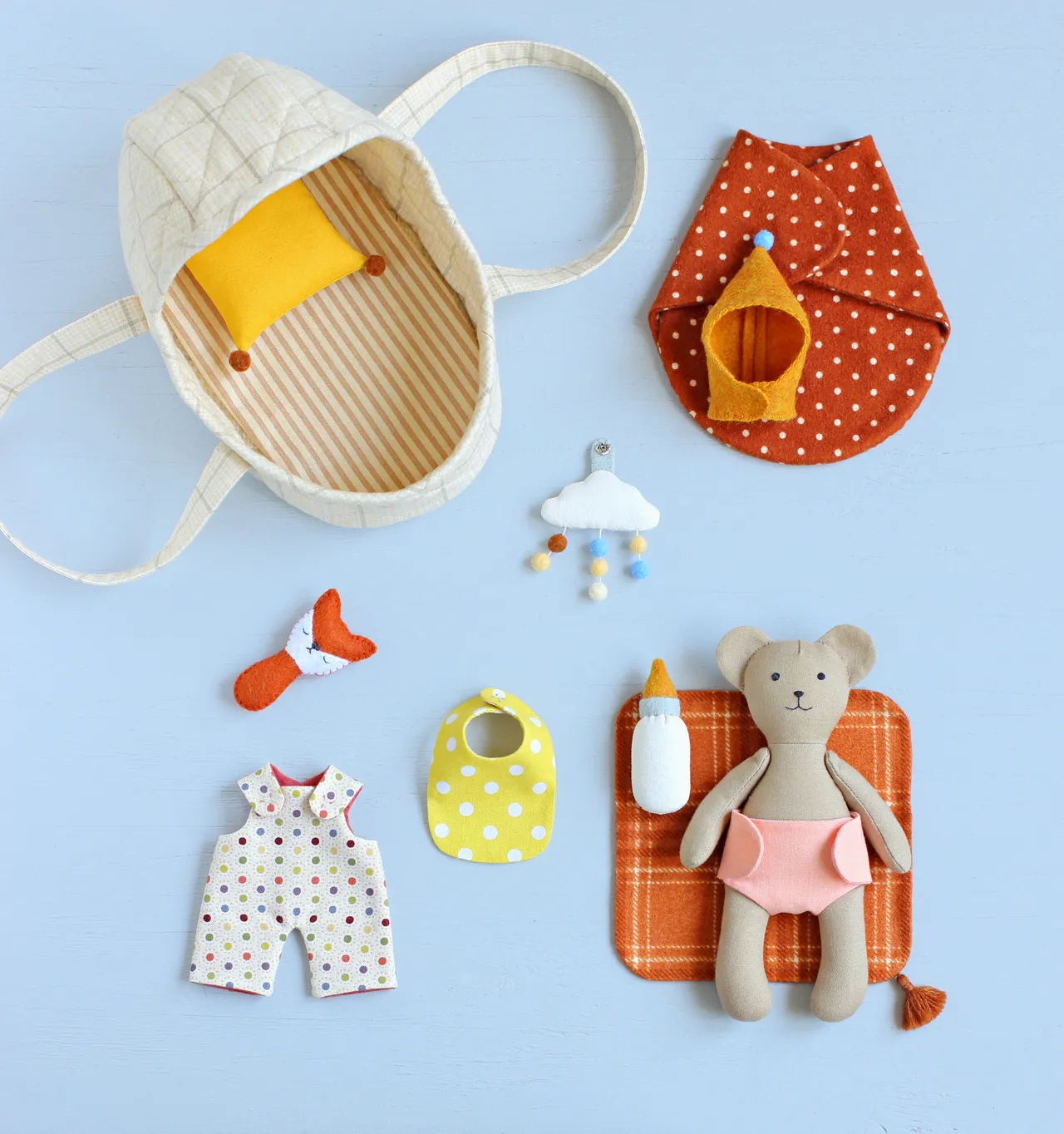 Someone’s getting sleepy watching their dreamy cloud mobile. This cozy set (bear + bassinet + mobile + all the tiny accessories) is available as a step-by-step sewing pattern!