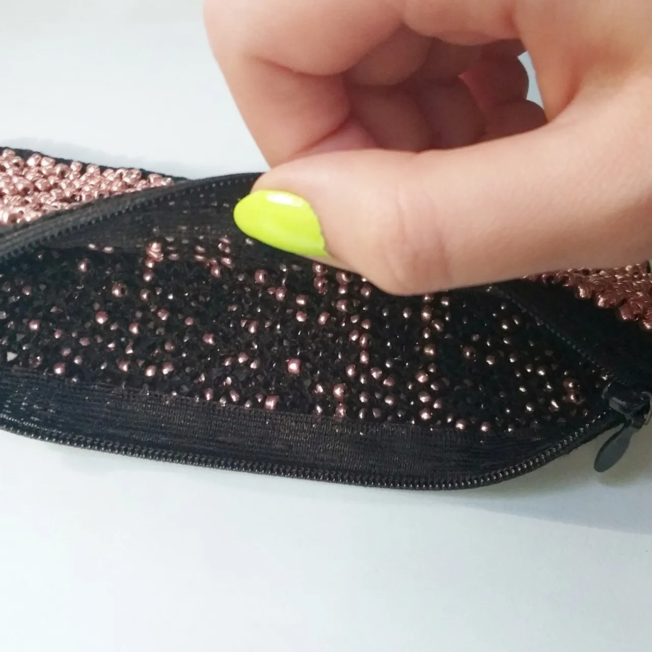 The process of creating a lace bag woven on bobbins. Bobbin lace making.