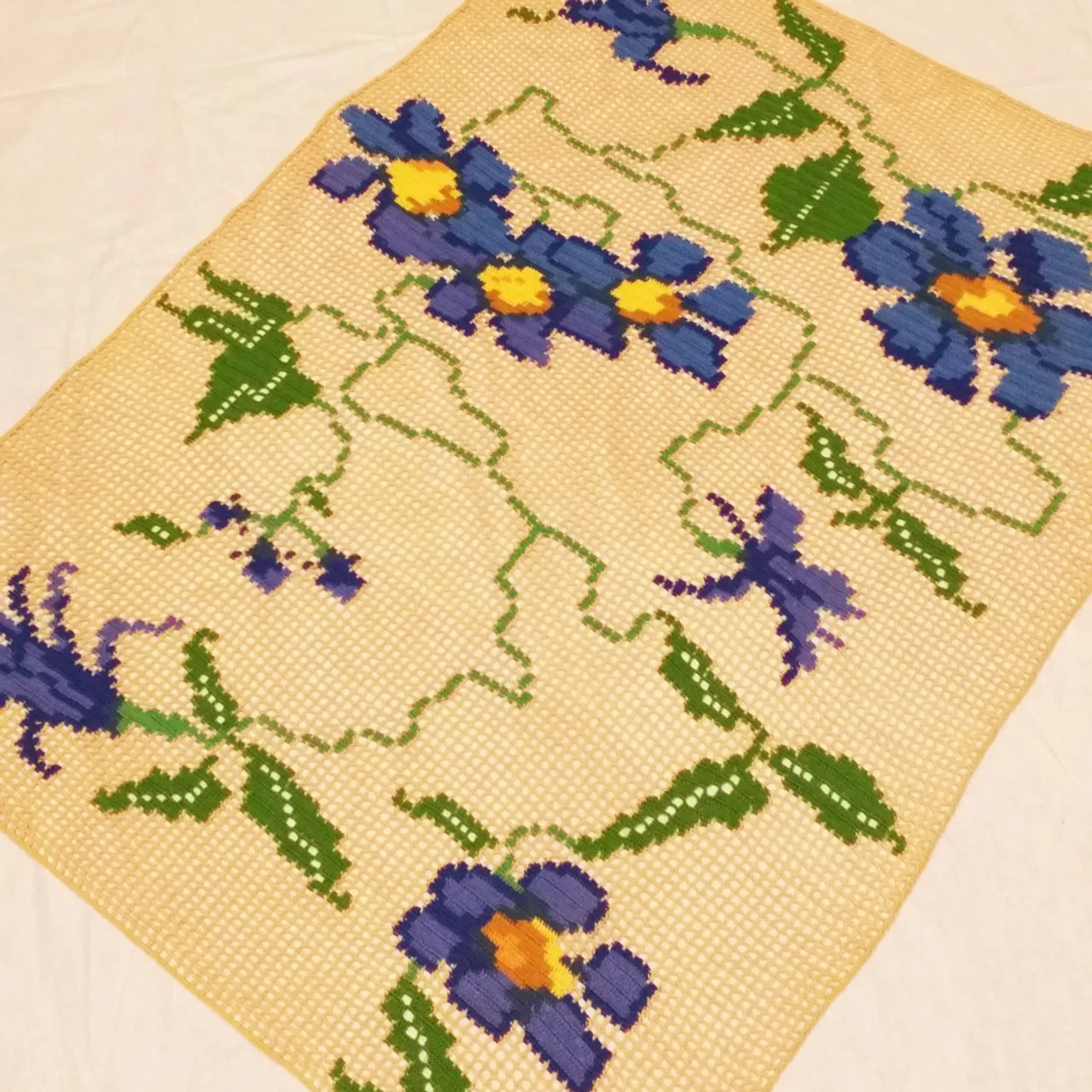 Crocheted tablecloth crocheted using different thread colors in fillet style.