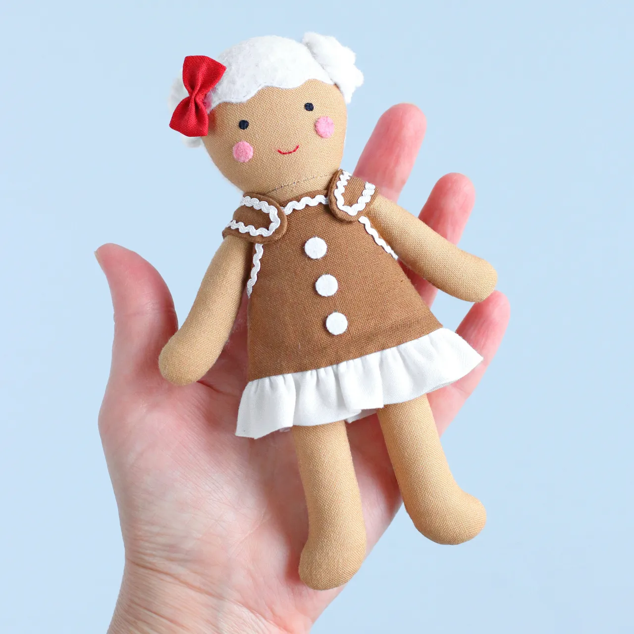 You can never have too many gingerbreads! :) Small, but exceedingly cute sewing project — a gingerbread house, which is actually a bag to carry a gingerbread boy or girl rag doll! Lots of fun to make and a great Christmas gift for a kid! Sew it quickly and easily with my sewing pattern!
