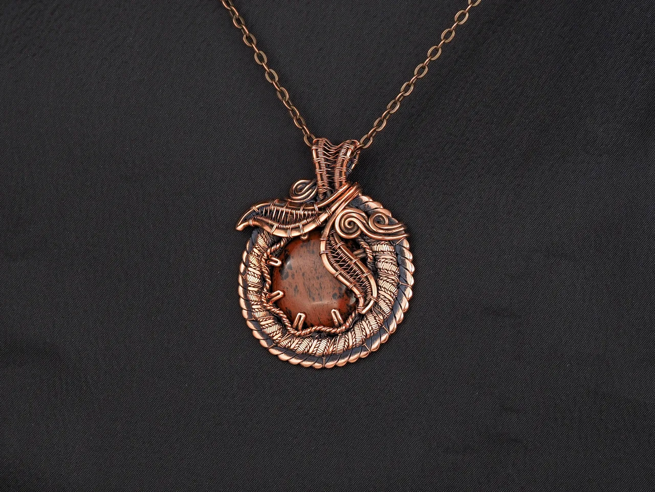 This unique was pendant handcrafted by weaving pure copper wire and natural red obsidian. Copper was artificially aged to create an antique look and to highlight the details of the wire work. Polished to a shine and varnished to prevent darkening.
Each piece is handcrafted by me from start to finish. Each piece is designed by me and is always unique. Each work in a single copy. Completely handmade!
This pendant can be a wonderful addition to your image, as well as a memorable gift!
You will get exactly the jewelry that you see in the photo.
Each piece is one of a kind and crafted with love!

Item details:
Height -5.8 cm
Width - 4.7 cm

If you have questions - just ask.
I wish you a happy shopping time and a good mood!