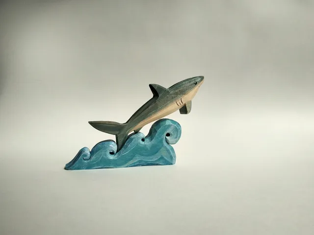 Wooden toy, shark on the waves, puzzle.

￼