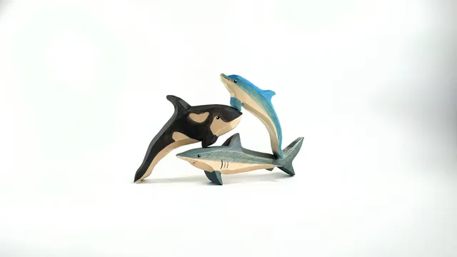 Wooden toys, inhabitants of the ocean, killer whale, dolphin, shark.