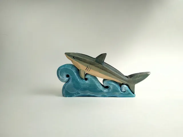 Wooden toy, puzzle, shark on the waves. Handmade, wood carving, painting.

￼