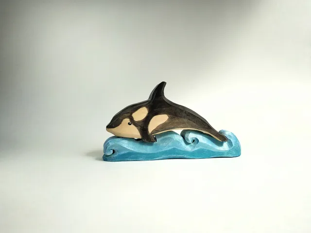 Wooden toy, killer whale on the waves, puzzle.