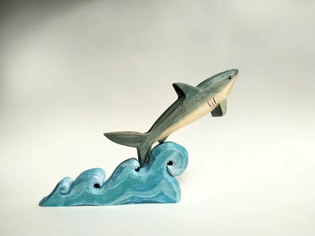 Wooden toy, puzzle, shark on the waves. Handmade, wood carving, painting.

￼