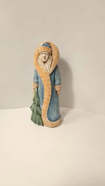 Miniature, wood carving, figurine of a snow maiden.