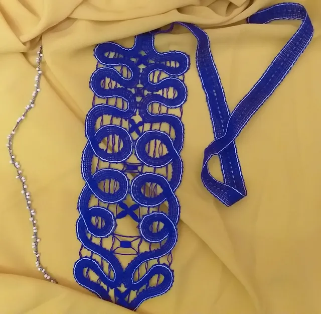 Lace weaving on bobbins.