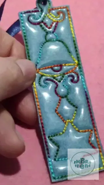 A bookmark or pendant with a Christmas pattern. You can make it for yourself or as a gift. Machine embroidery design. #Inthehooppendant #Christmasembroiderydesign #ITHChristmasbell #gift #Instantdownload