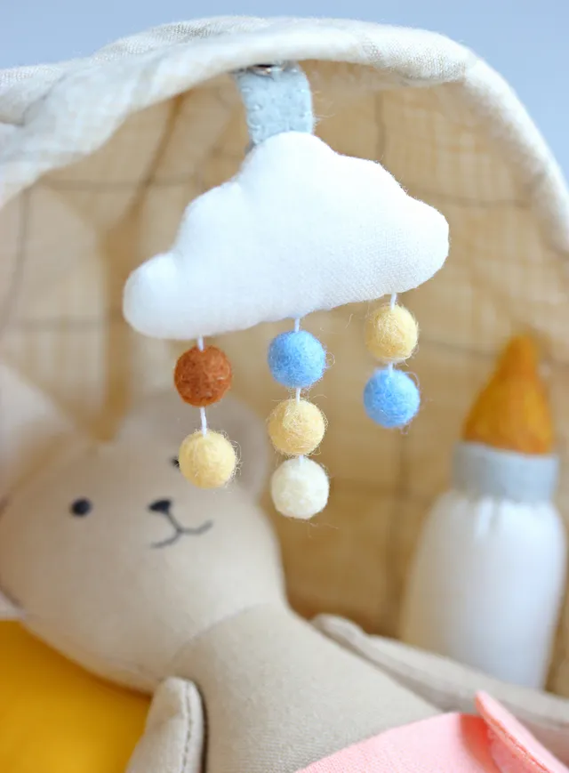 Someone’s getting sleepy watching their dreamy cloud mobile. This cozy set (bear + bassinet + mobile + all the tiny accessories) is available as a step-by-step sewing pattern!