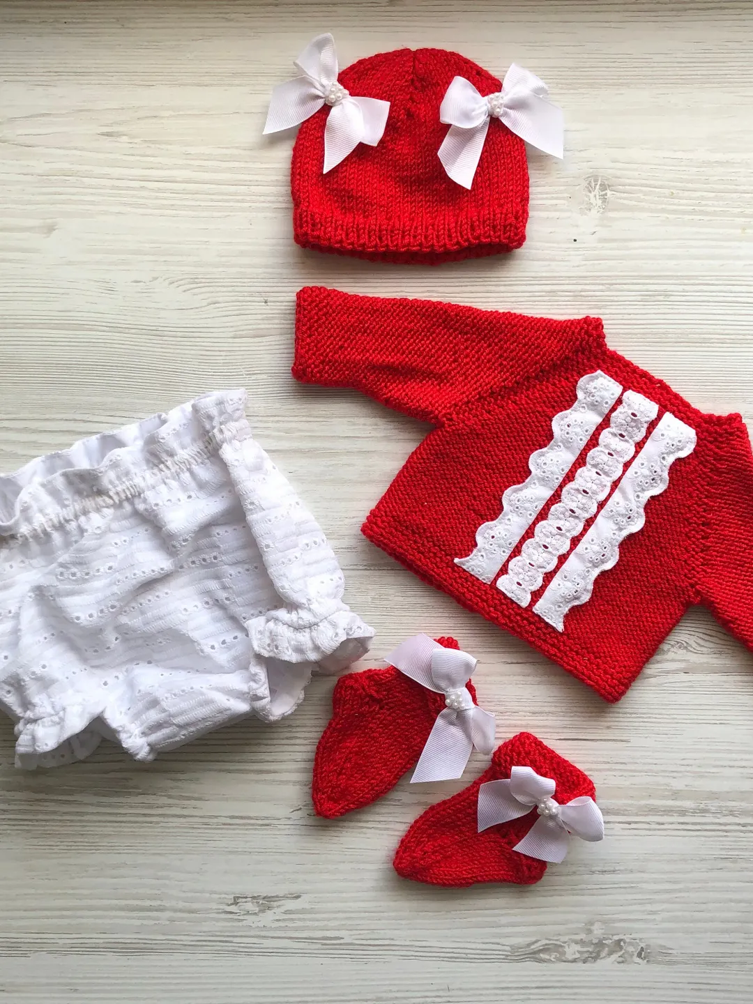 Knit red sweater with white lace, white lace panties, hat with bows and pearls, socks. Take home outfit for baby. Baby shower gift for girl
