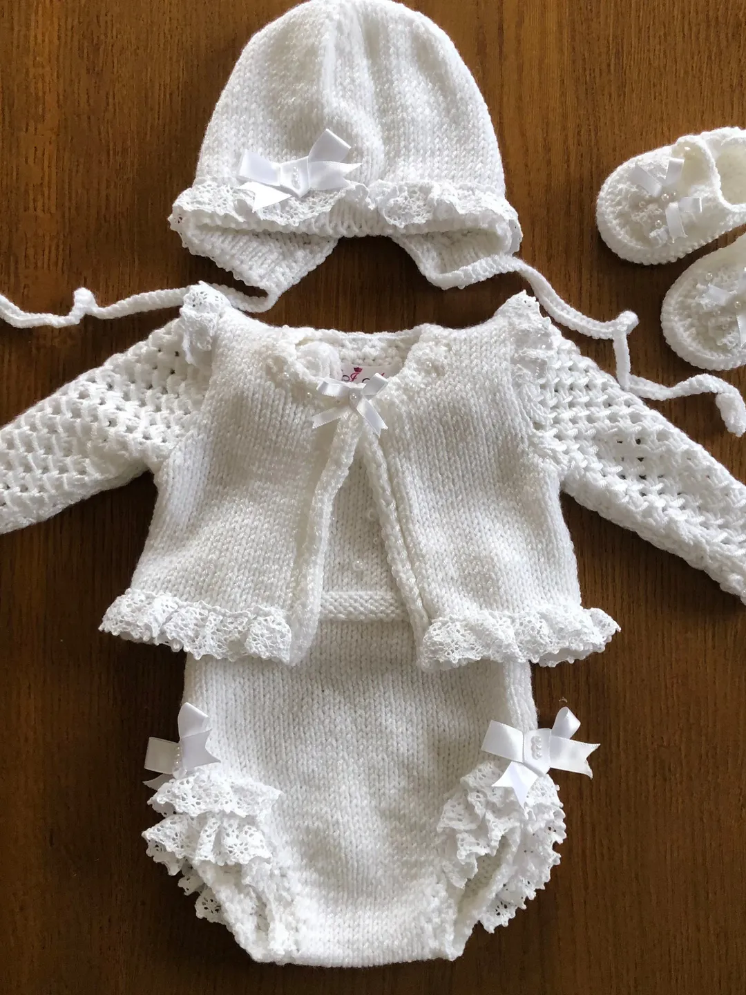 White, knit romper, jacket, hat and booties with lace and pearls for baby girl. Take home outfit for girl. Photo props for baby girl.