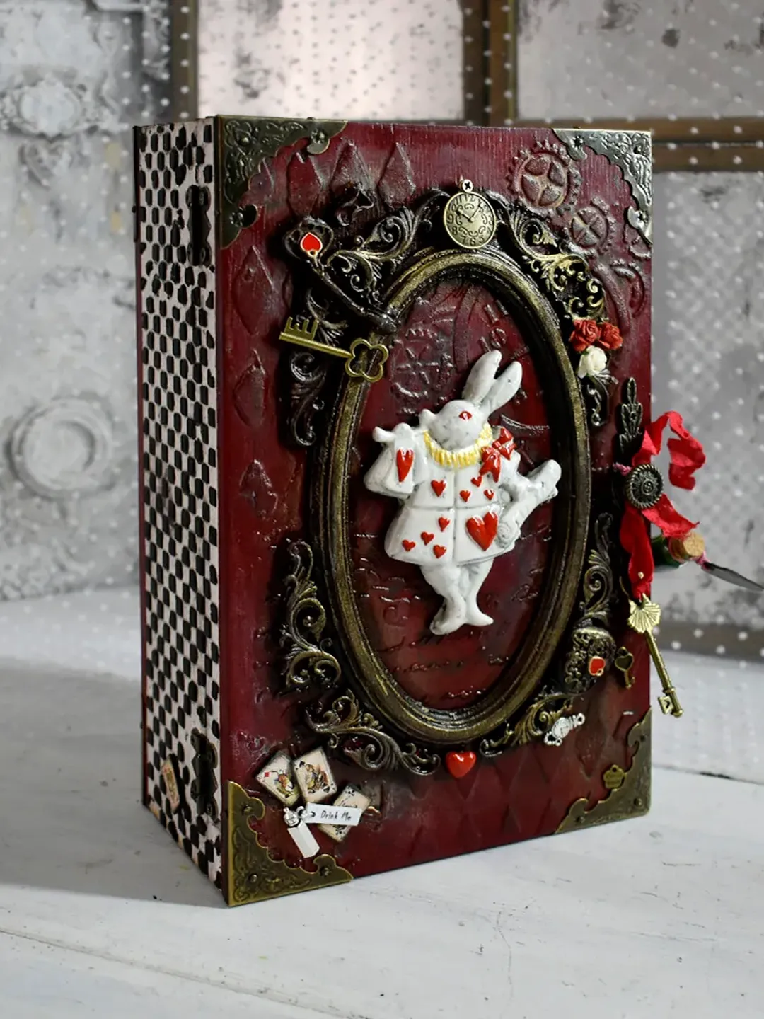 A red book-box with a white rabbit from Alice in Wonderland