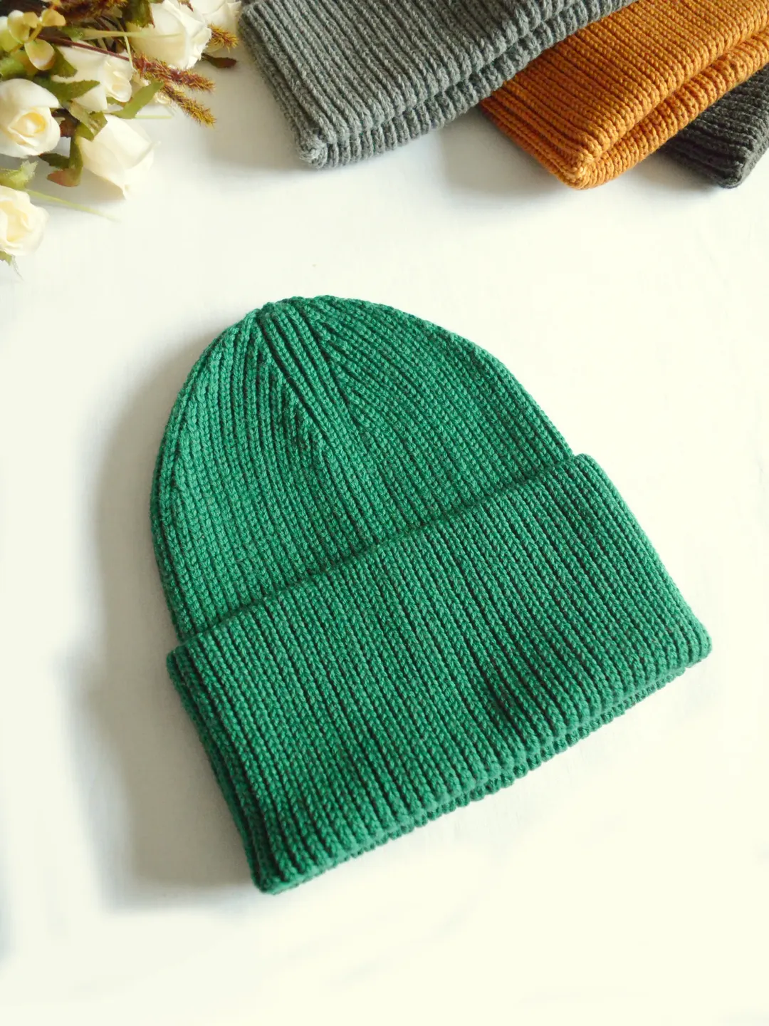 Knitted hat with lapel in emerald green
