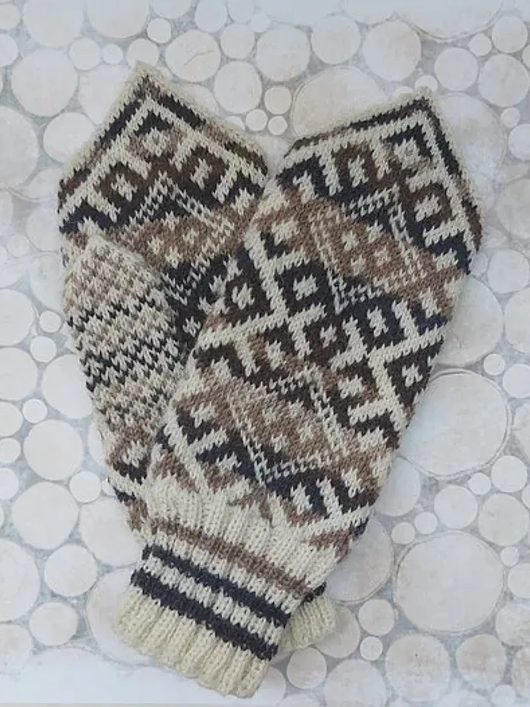 Women's hand-knitted wool mittens are very warm with a pattern