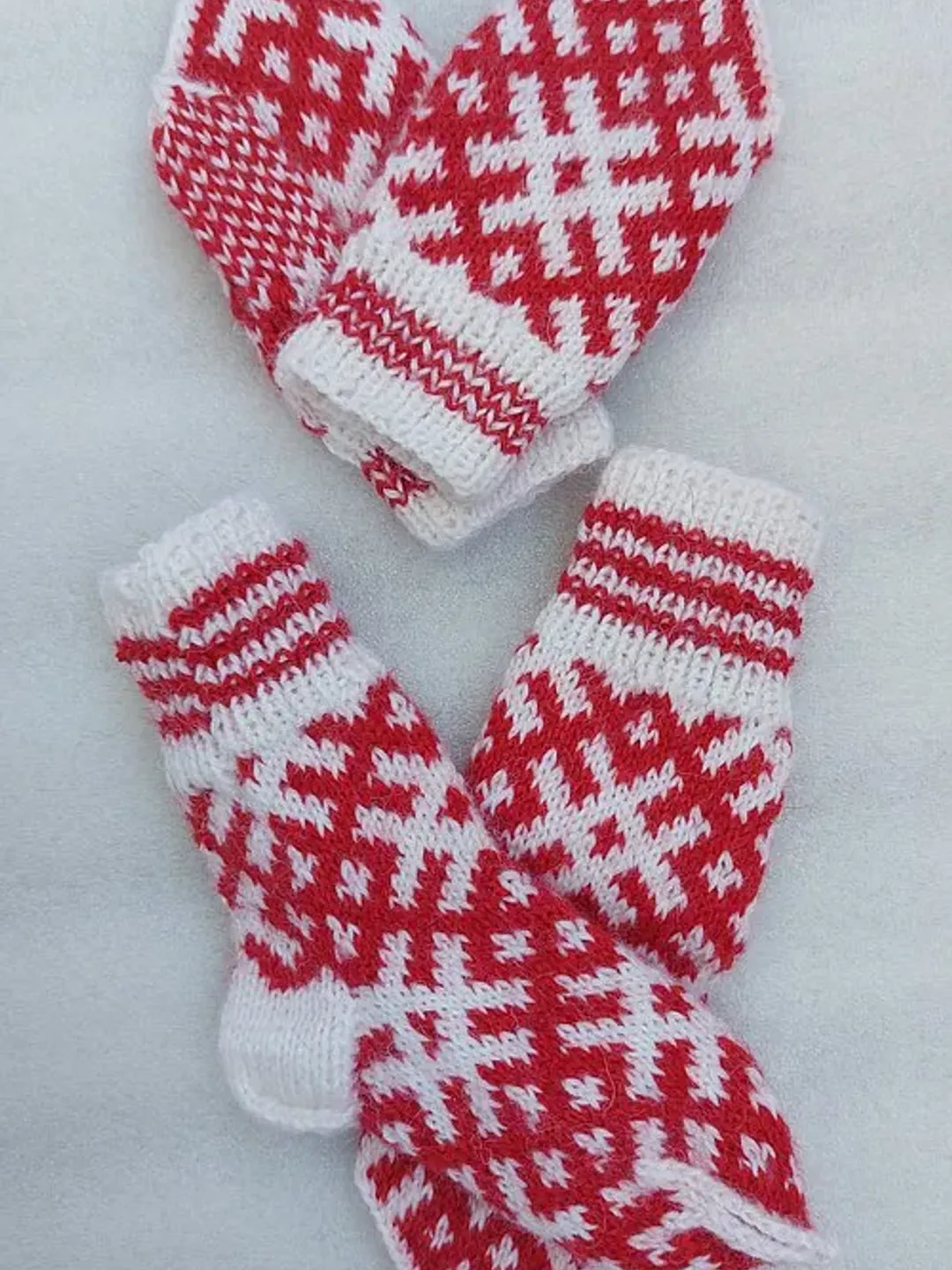 Children's knitted set woolen socks and handmade mittens with a pattern