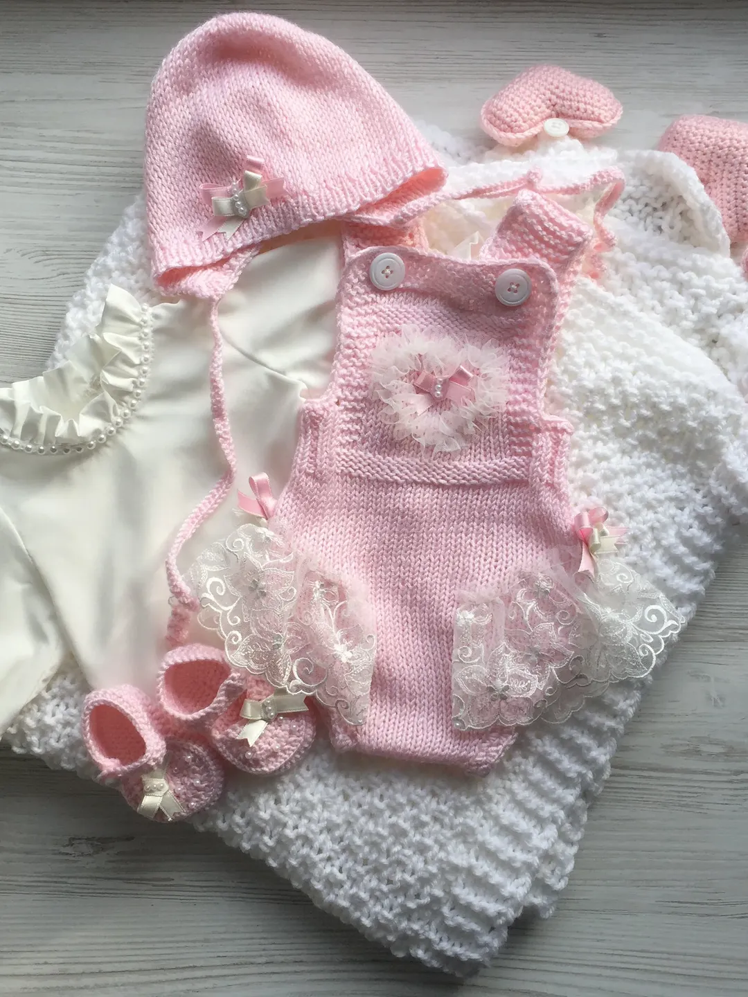 Knit clothing set for baby girl. Blanket with four toys, romper, blouse, hat and booties. Take home outfit for girl. Baby shower gift