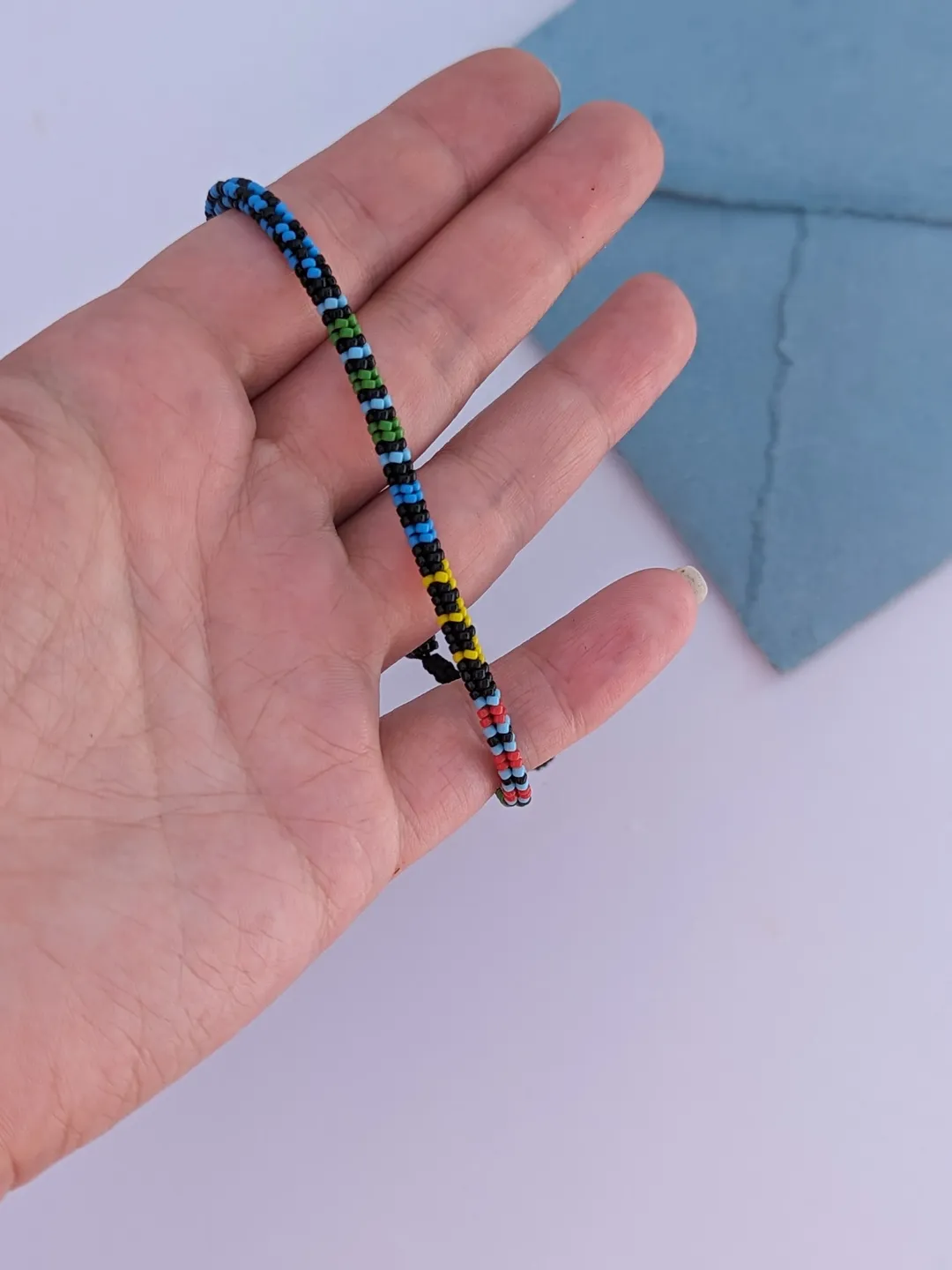 Thin beaded men's bracelet in colorblock design