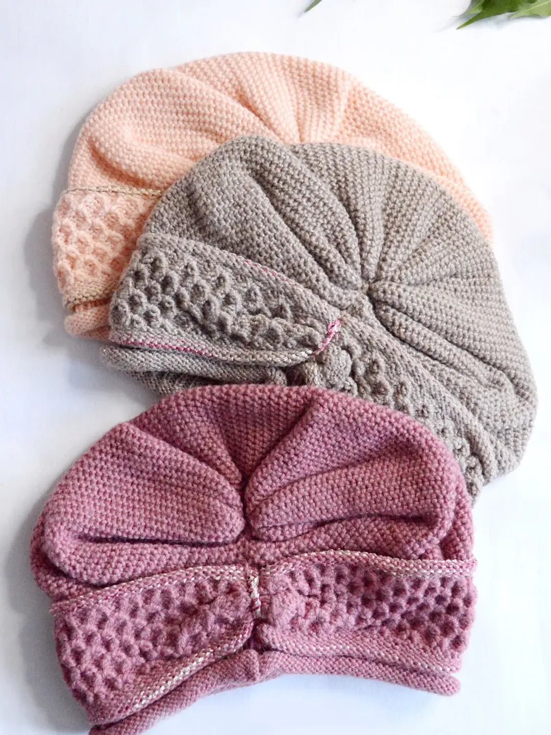 Stylish woman's hat. Knitted hat with drapery.