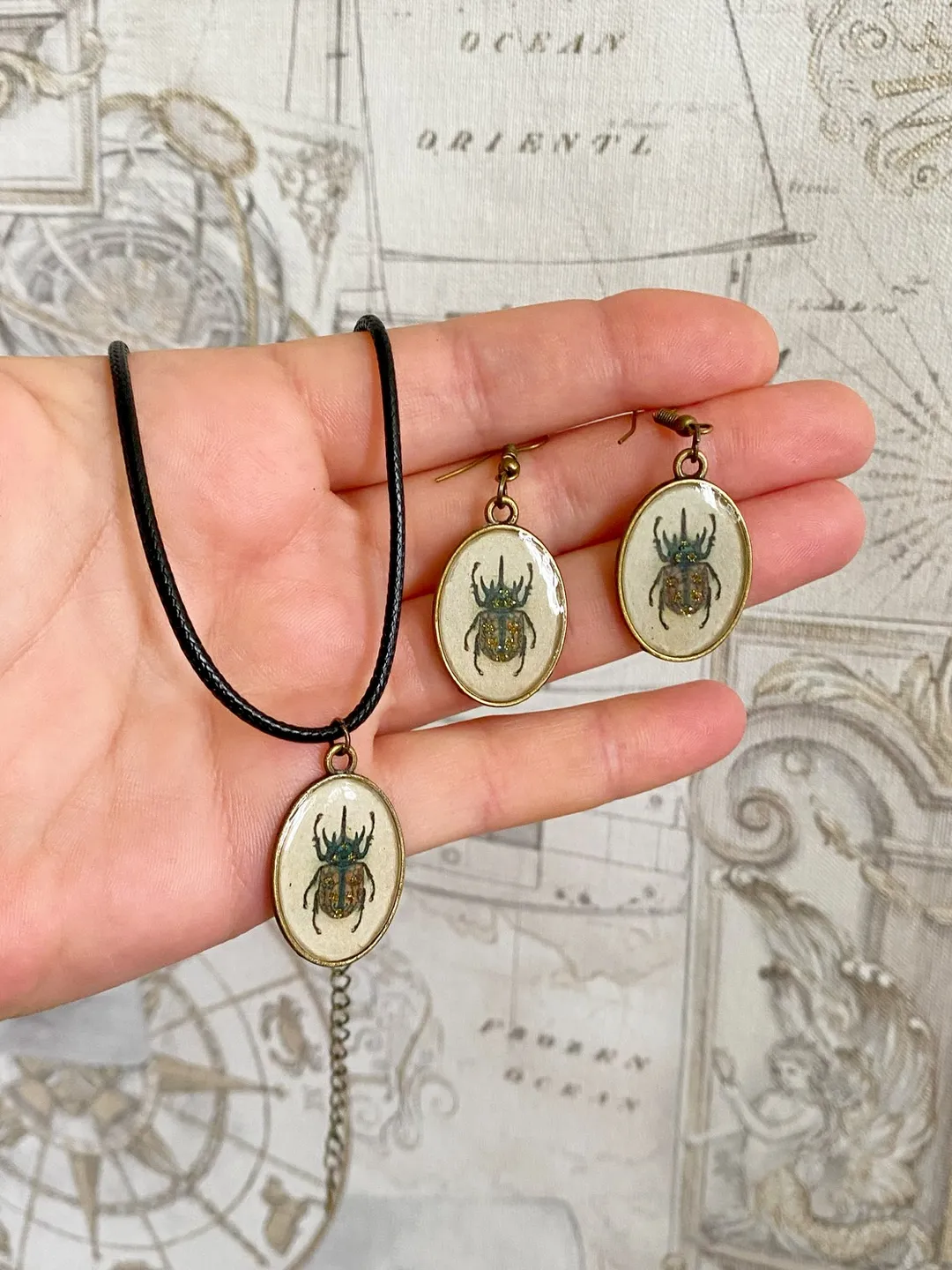 A set of jewelry with the image of beetles. Individual design.