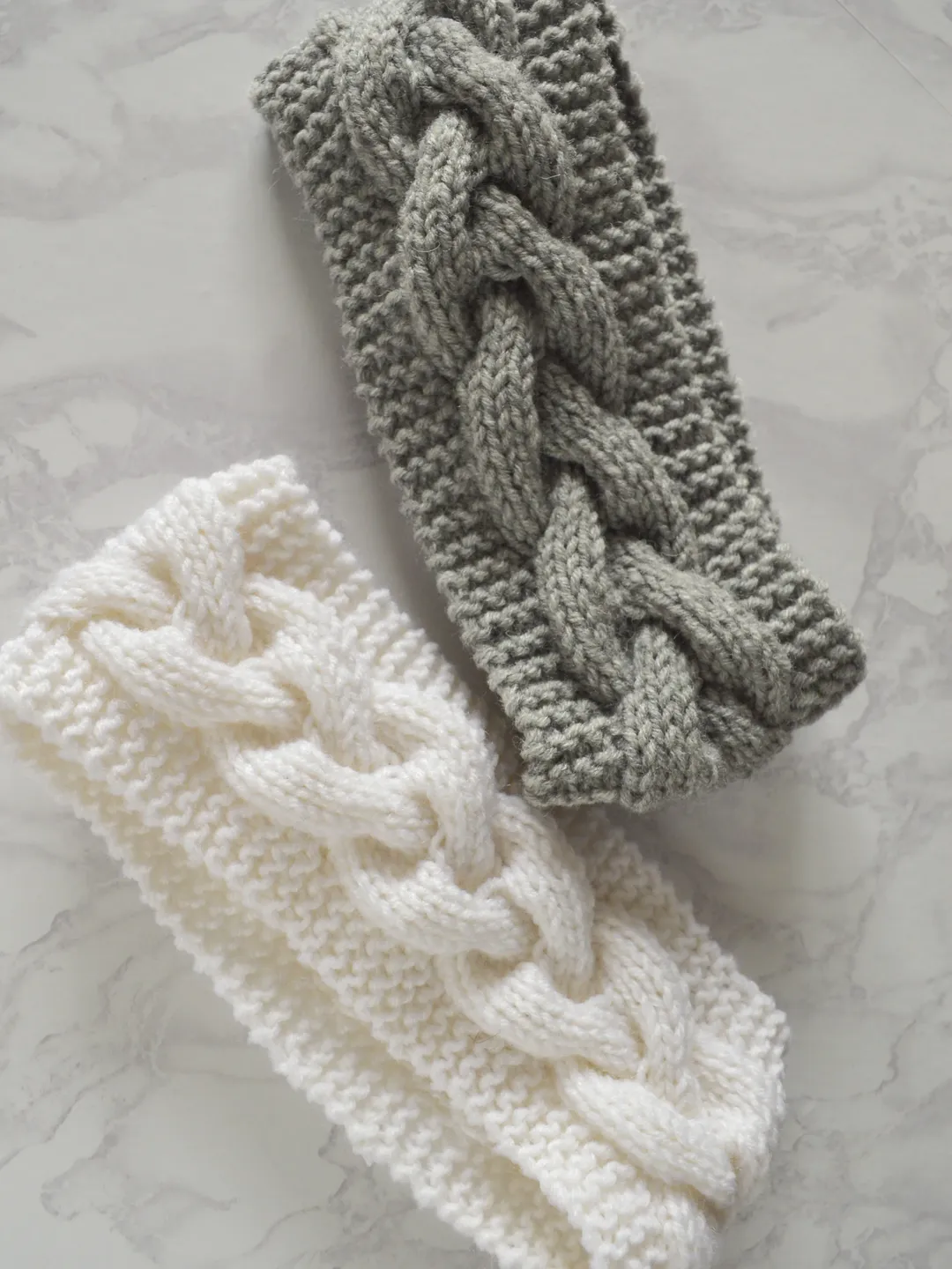 Knitted headband in gray with braid pattern