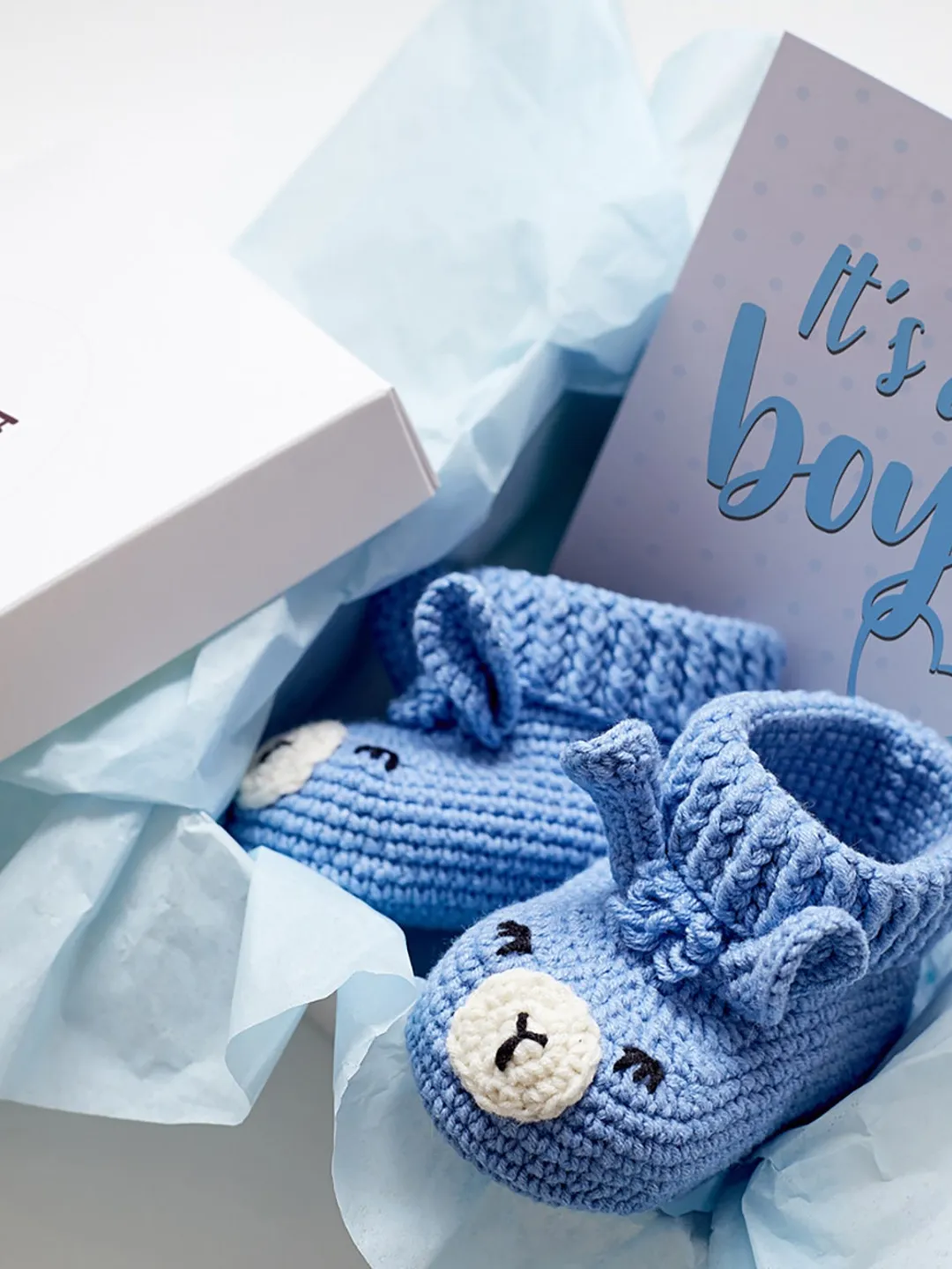 Pregnancy gift box for Its a boy baby gender reveal party event. Cute blue farm animal llama booties for newborn. Rustic nursery decor gift