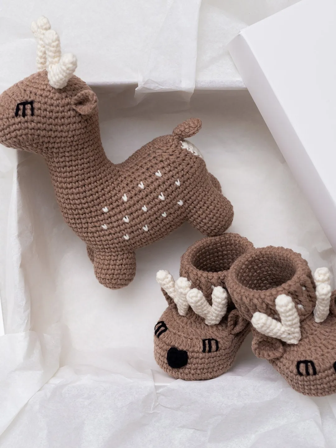 Expecting for a baby on Christmas gift basket with crochet Christmas deer and soft pregnancy baby booties