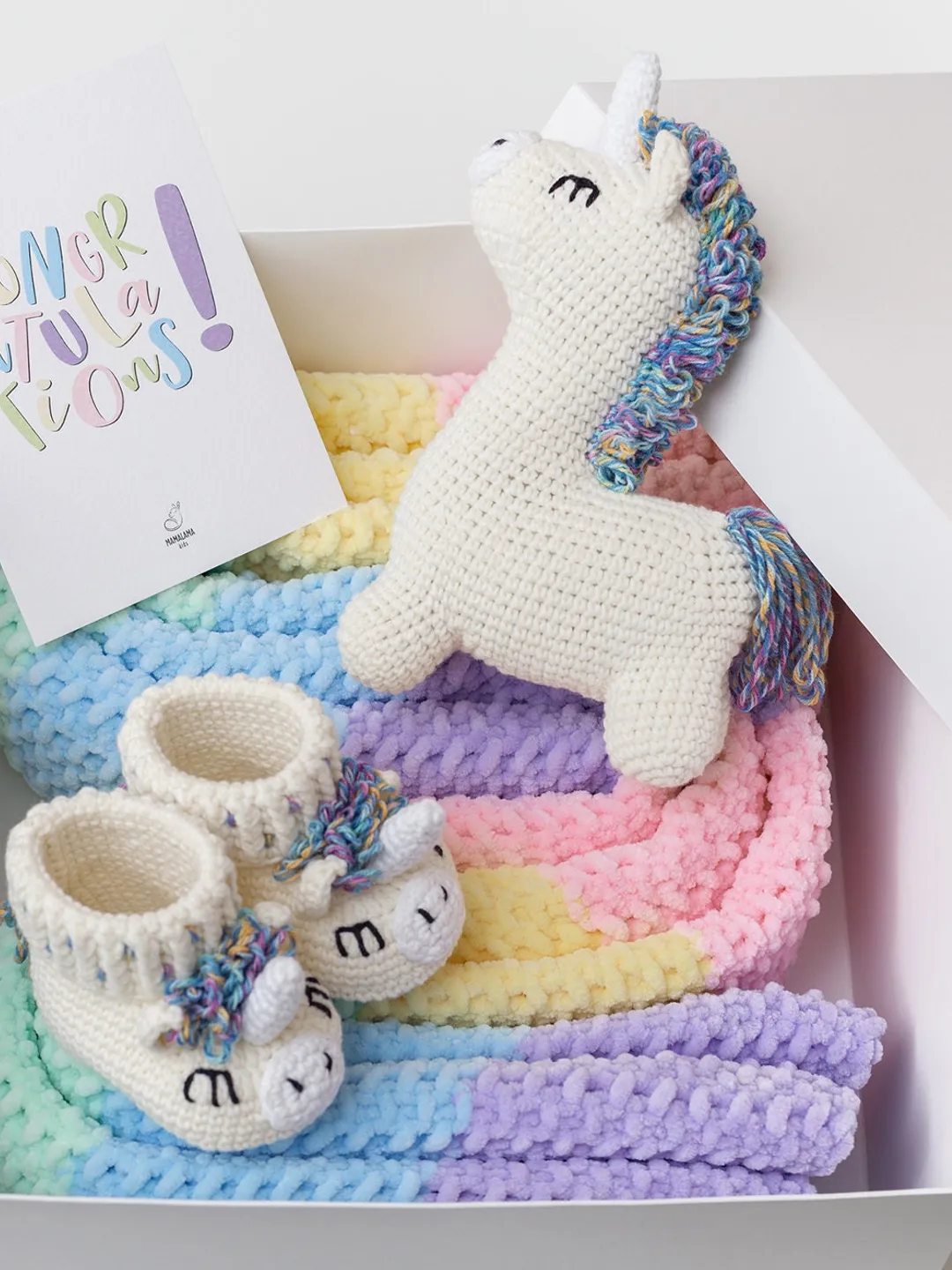 Pregnancy gift basket with crochet unicorn booties sweet toy and rainbow striped multicolored blanket Bright newborn new mom parents gift