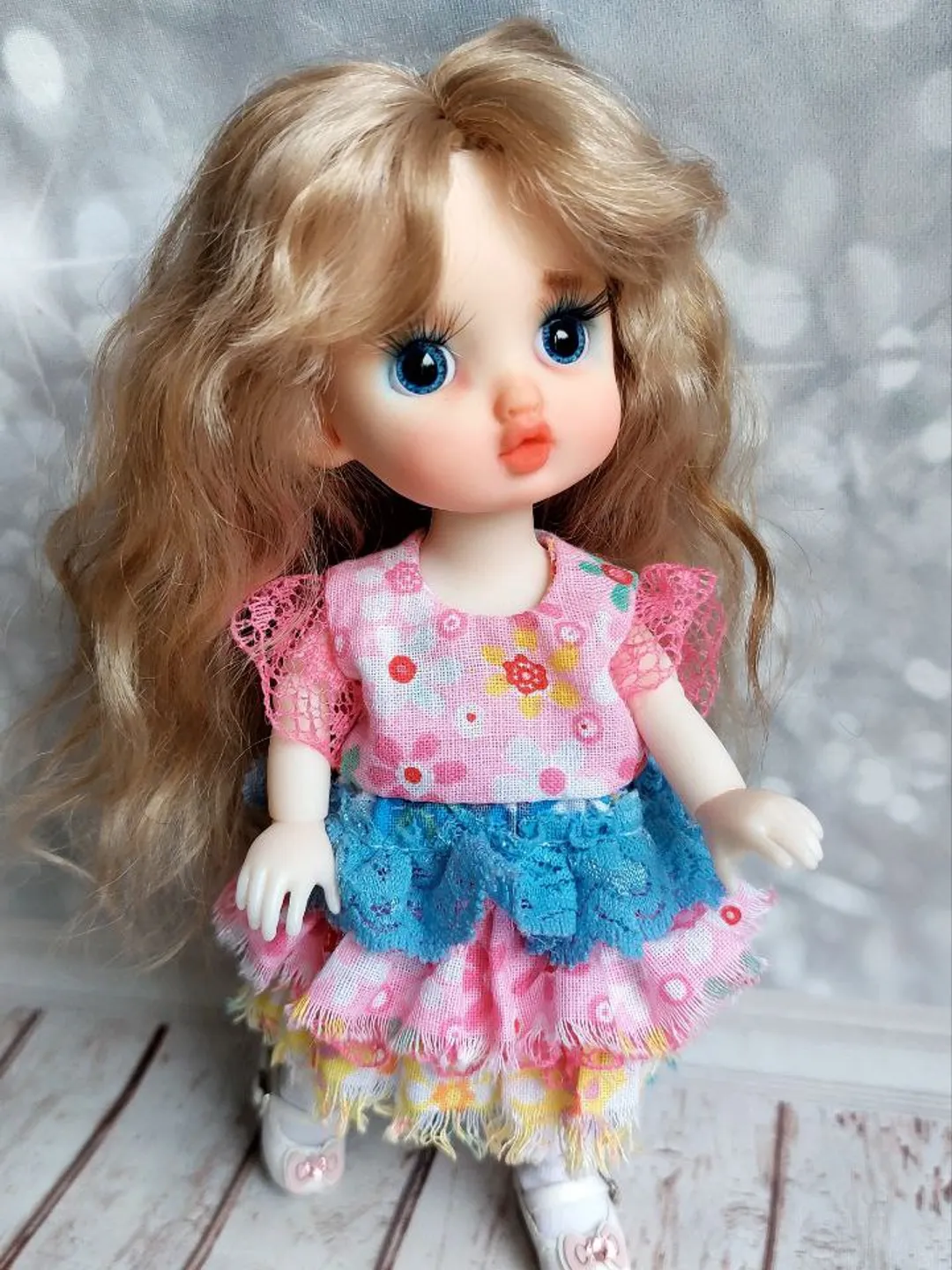 Blonde doll with blue eyes. Small doll on an articulated body.