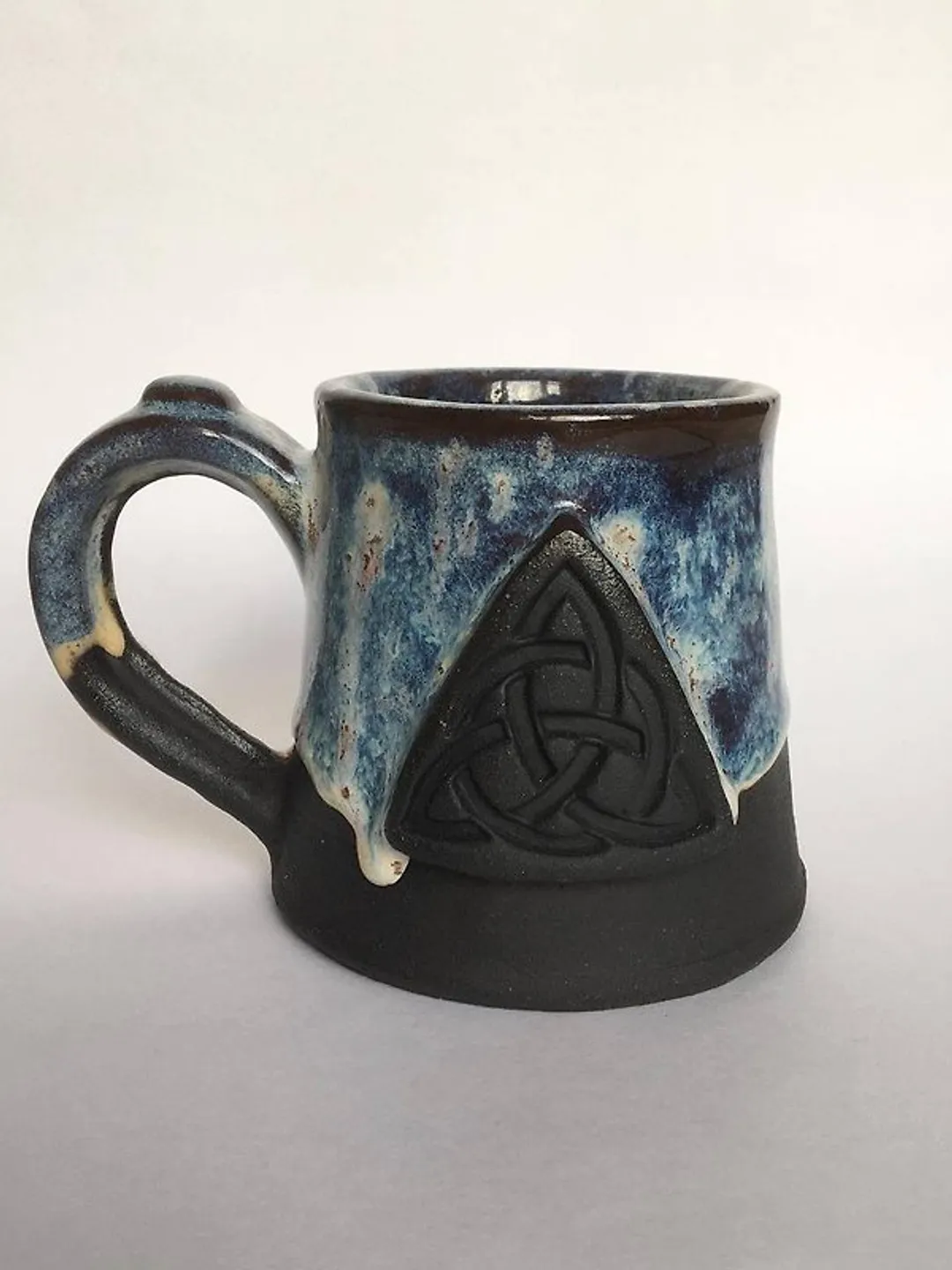 Trinity knot Triquetra in circle blue and black galaxy glazed stoneware mug