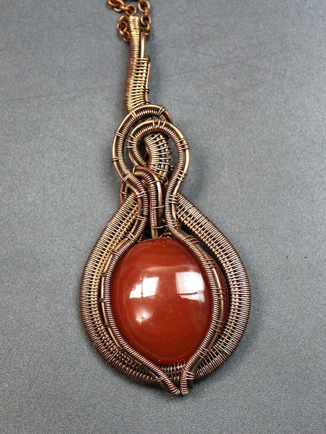 Handmade Pendant made of copper wire and natural carnelian stone