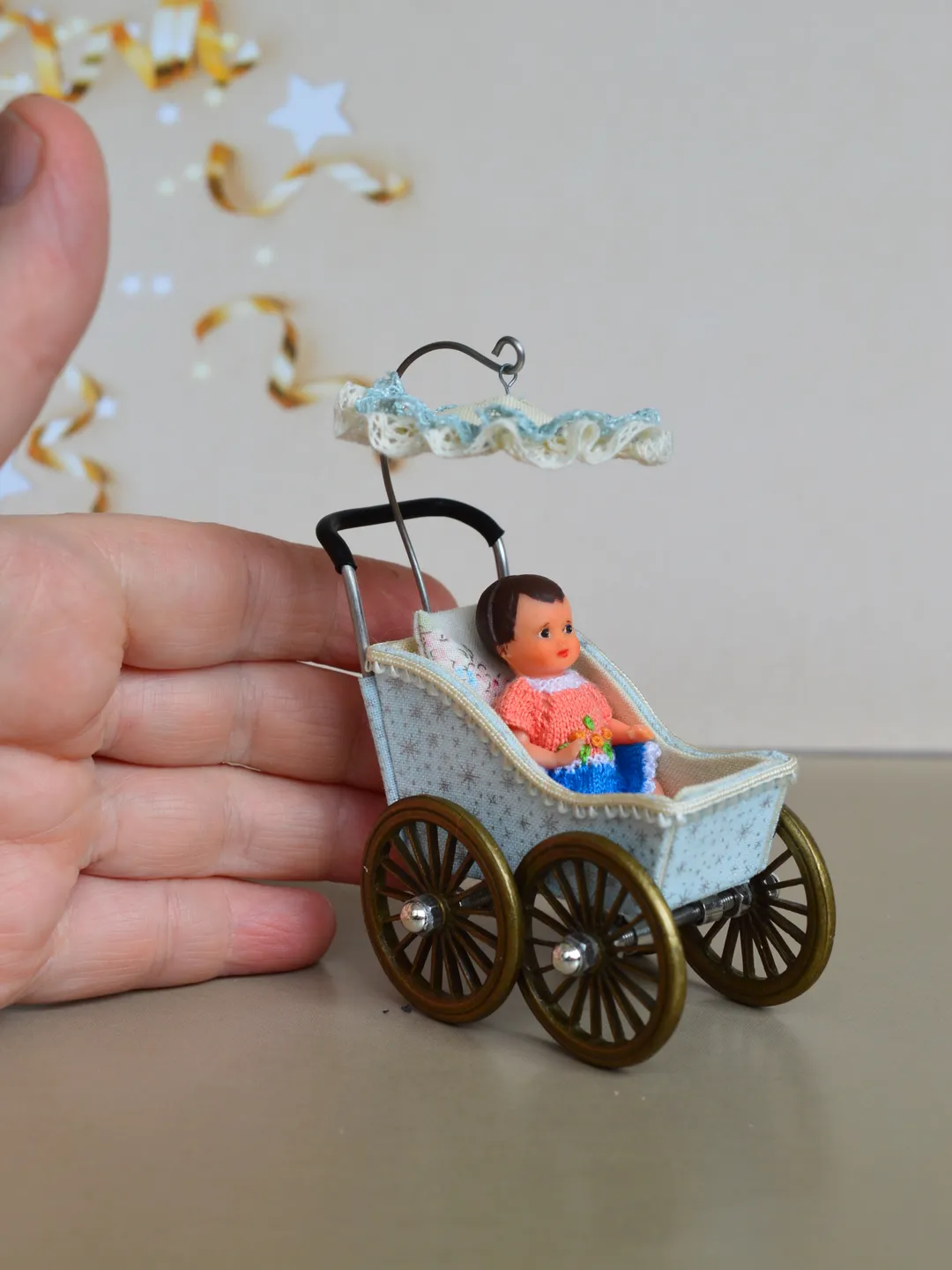 Miniature toy stroller for a little doll.  Pram for the little poopsie.