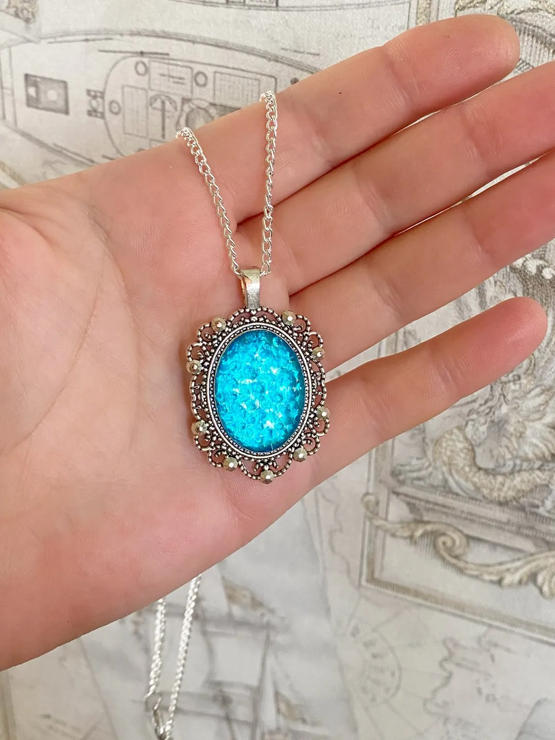 Bright, turquoise pendant on a handmade cord. Handmade jewelry with turquoise rhinestones.