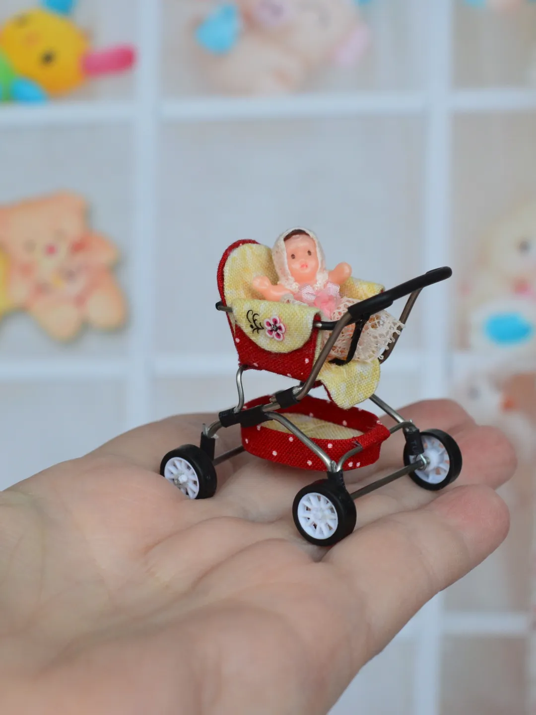 Miniature toy doll stroller in 1/24 scale. Complete with baby doll. Red handmade stroller.