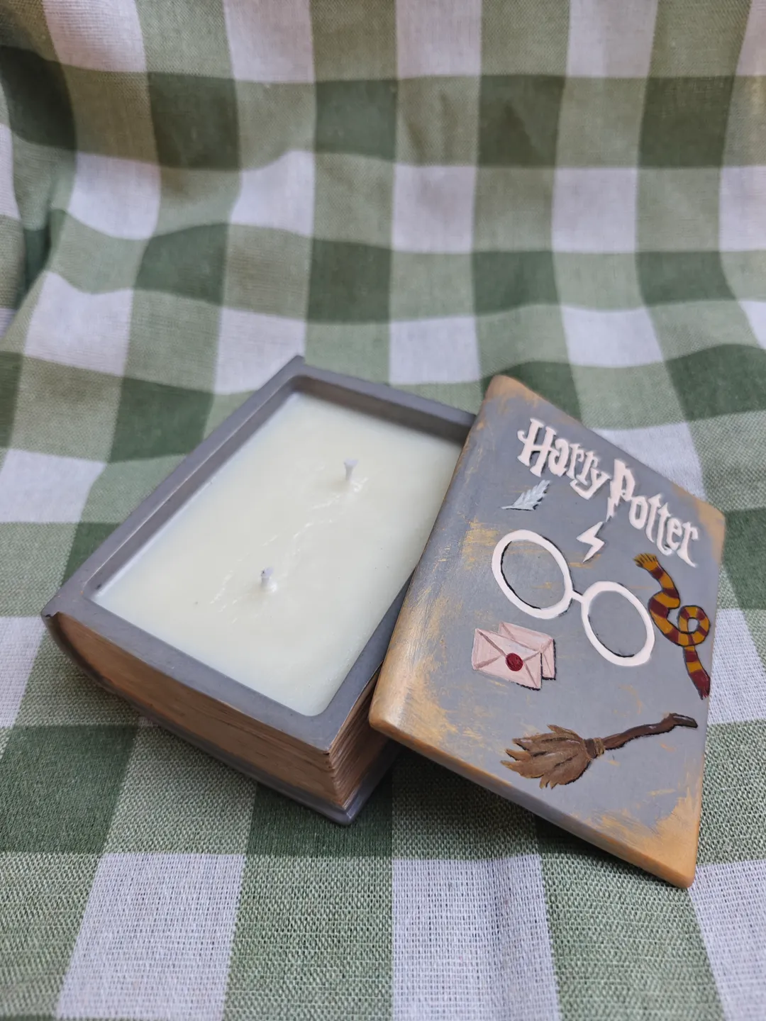Candle in a plaster form of a book
