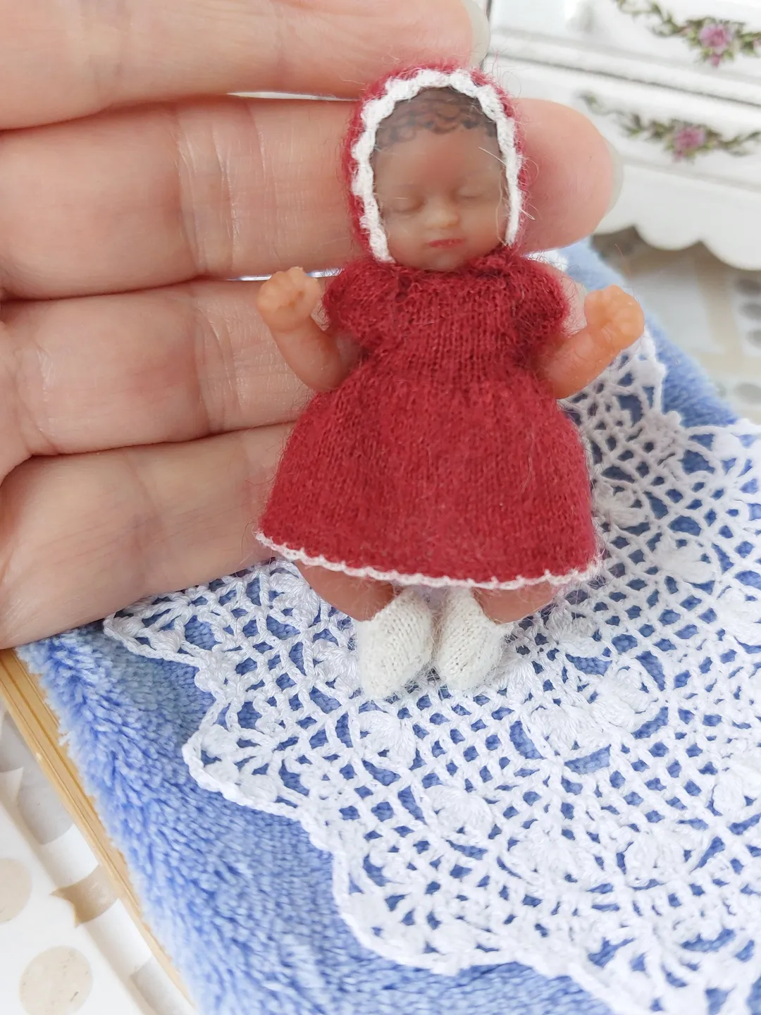 Miniature knitted red dress with white pants, socks and a hat for the silicone doll "My Mini Baby" by ZURU