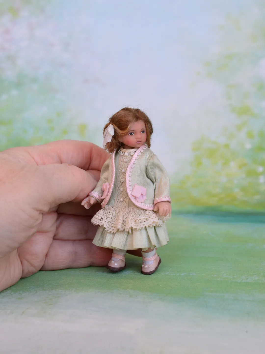 Miniature girl doll for Victorian dollhouse in 1/12 scale.