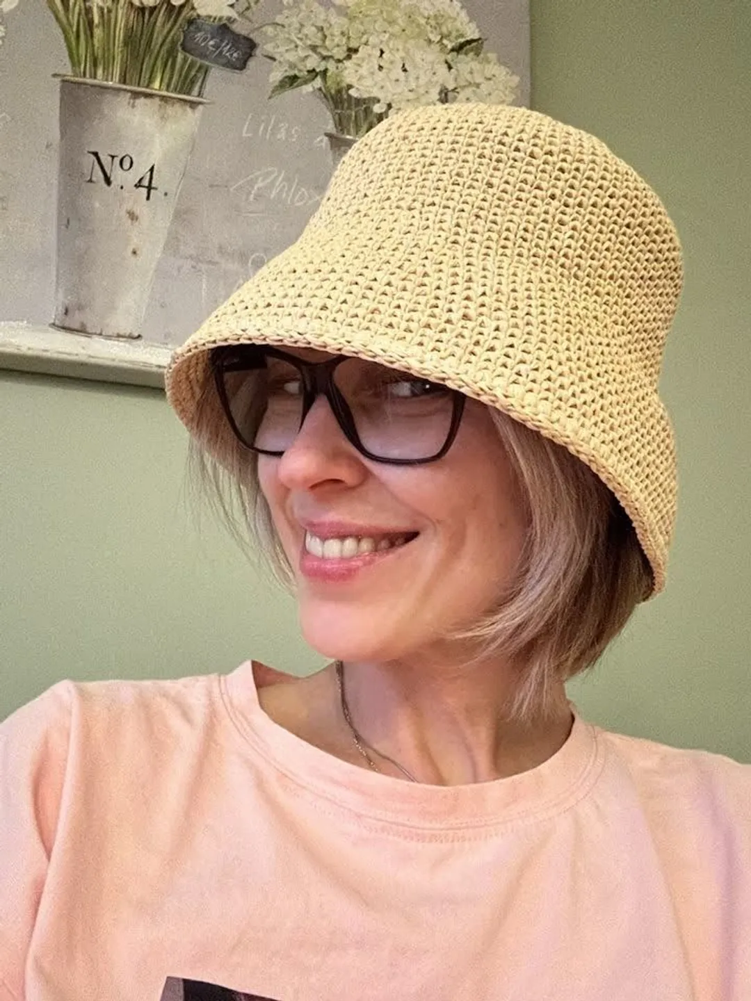 A straw basket hat made from woven raffia straw.