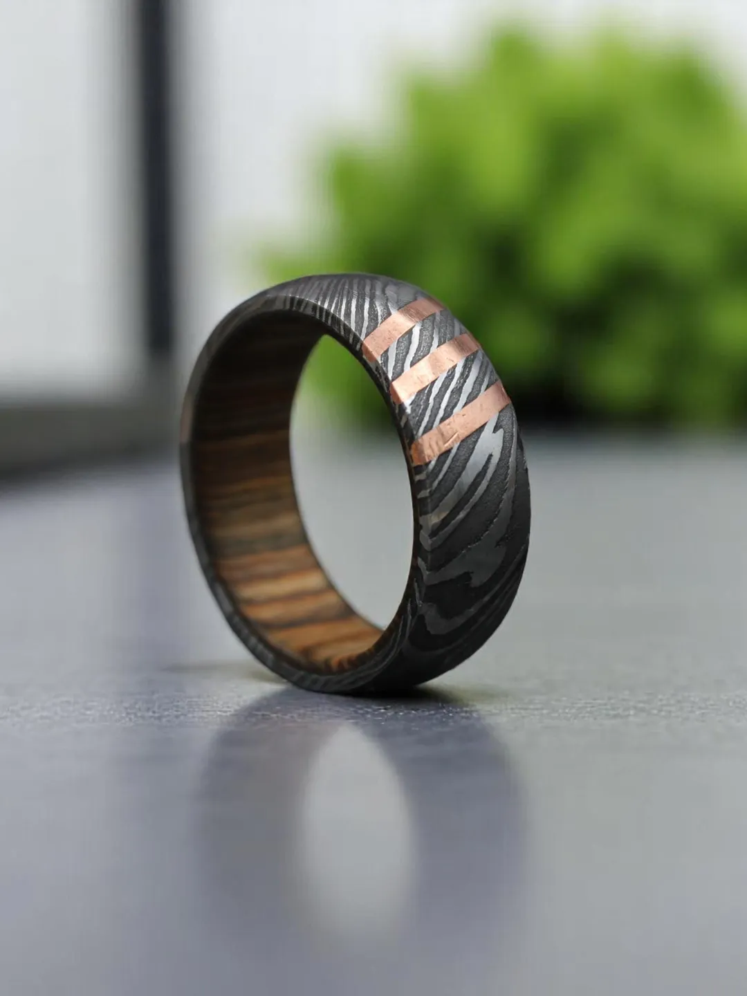 Hand-Forged Damascus Steel & Whiskey Barrel Wood Ring with Copper inlay.