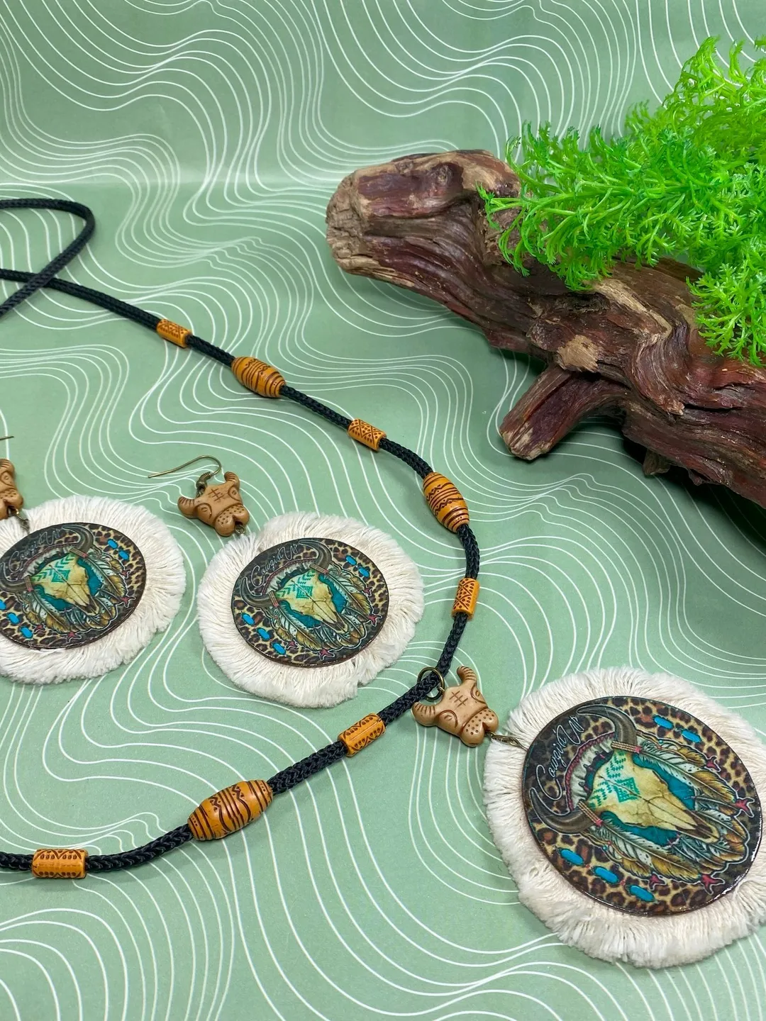 A set of interesting handmade jewelry.Handmade jewelry. Author's design. Set of earrings + pendant on a cord.