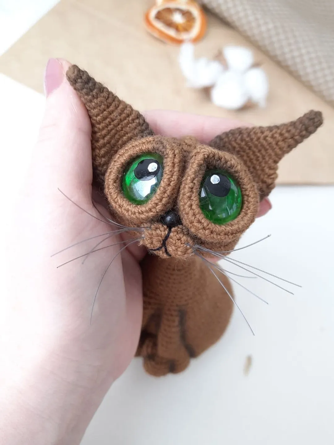 Crochet sculpture of a graceful brown cat with green eyes. Big-eyed cat as  a gift for cat lovers., image size:1080x1440