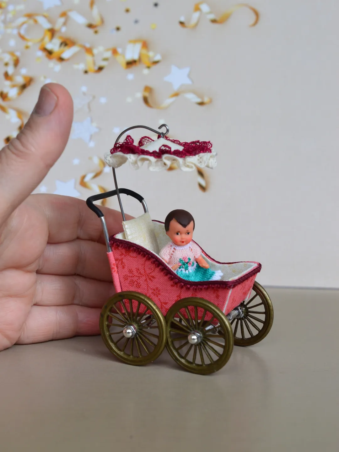 Miniature toy stroller for a little doll.  Pram for the little poopsie.