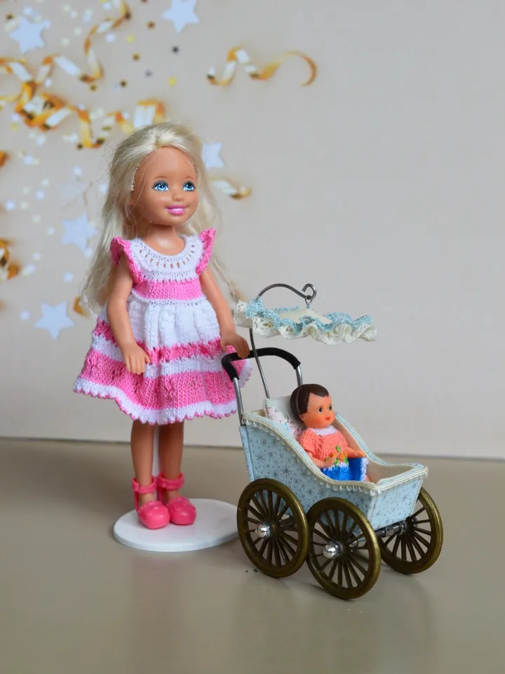 Miniature toy stroller for a little doll. Pram for the little poopsie.