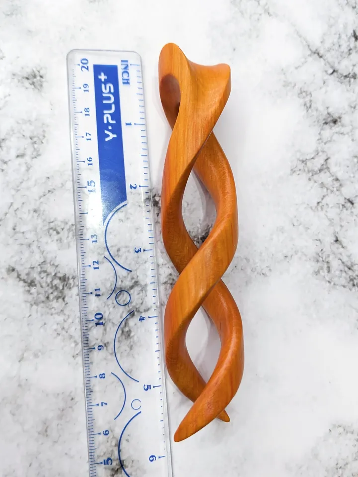 Spiral clip made of stabilized hornbeam orange. Twisted wooden hair fork.