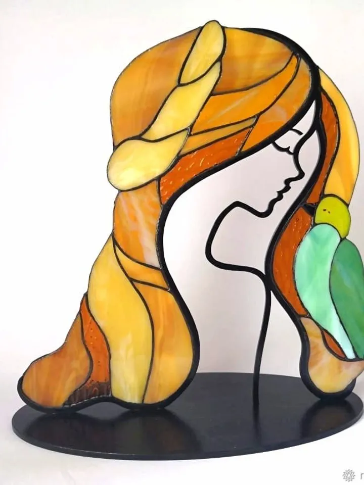 Girl with a Bird. Tiffany Stained Glass, Stained Glass Featuring a Girl and a Bird, Stained Glass with a Girl and Bird on a Stand, Stained Glass "Girl and Bird" on Base, Stained Glass Featuring a Girl and Bird