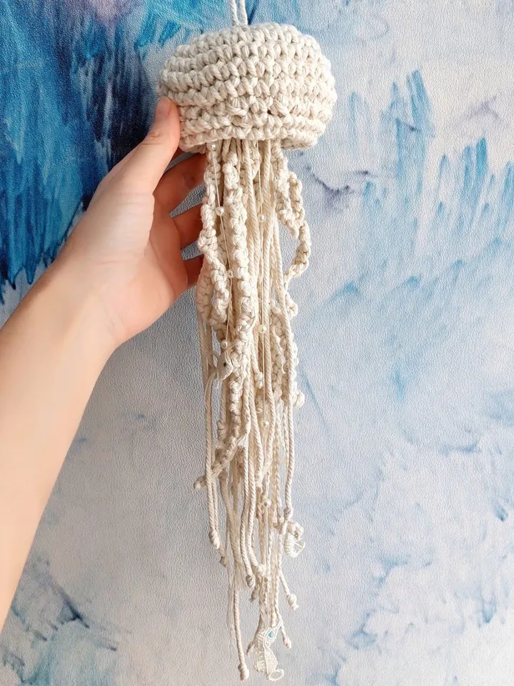 Pendant decoration in the shape of a jellyfish made of macramé. Modern macramé. Home decor in coastal style. crochet jellyfish