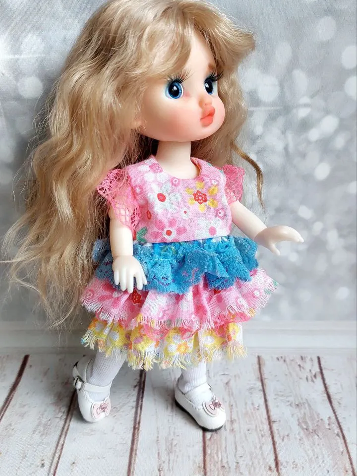 Blonde doll with blue eyes. Small doll on an articulated body.